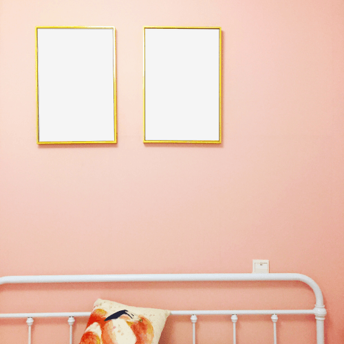 Two Gold Frame Mockups Hanging On A Wall
